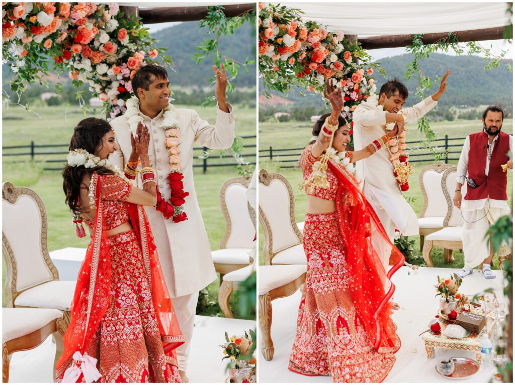 bride and groom celebrating with arms up in the air after ceremony
