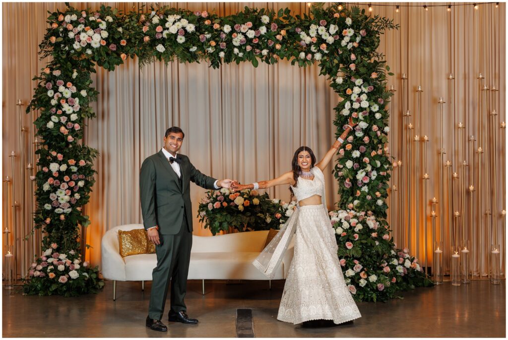 bride and groom standing in front of of floral decor at Spruce Mountain