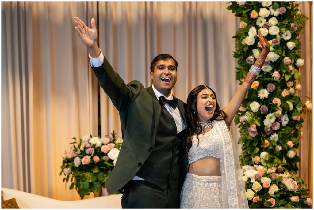 bride and groom waving to guests