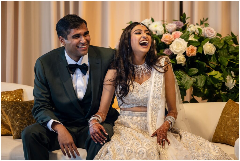 bride and groom laughing to toasts 