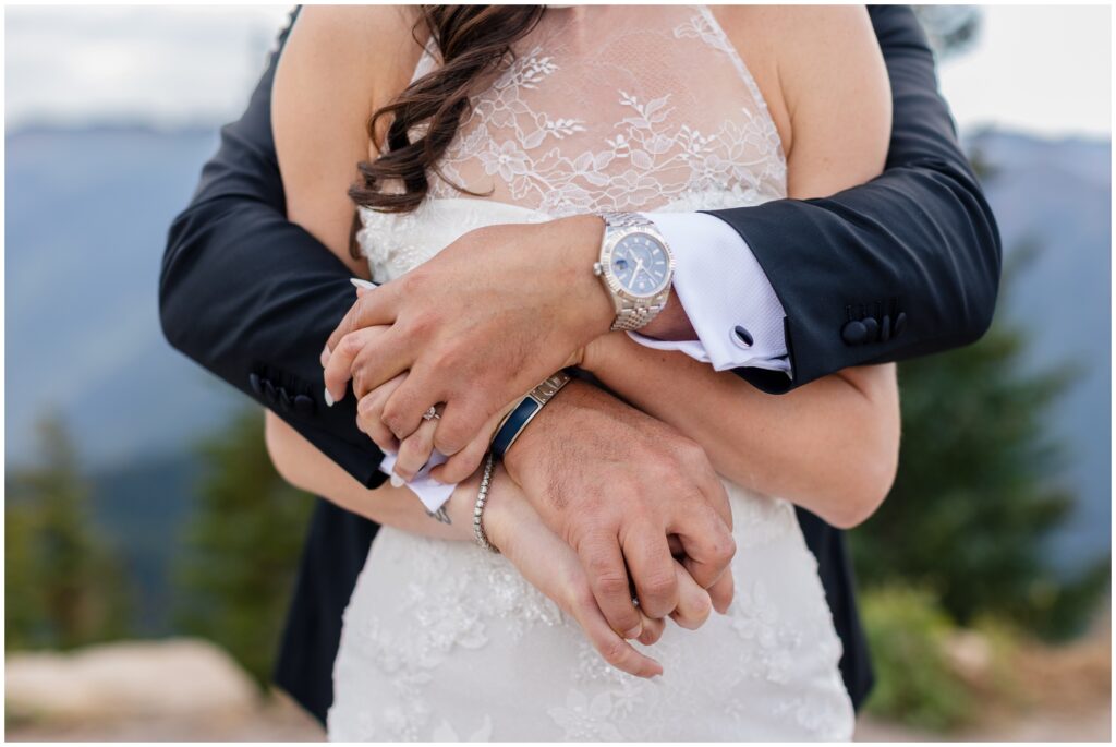 groom arms wrapped around bride