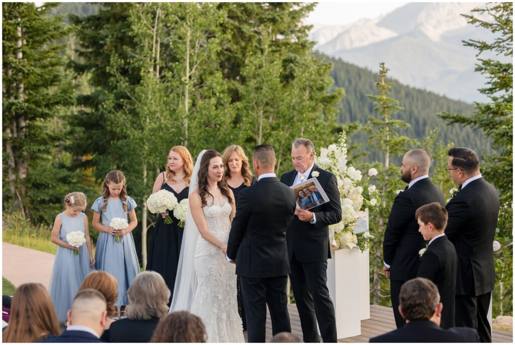 Bride and groom holding hand and looking at each other during ceremony