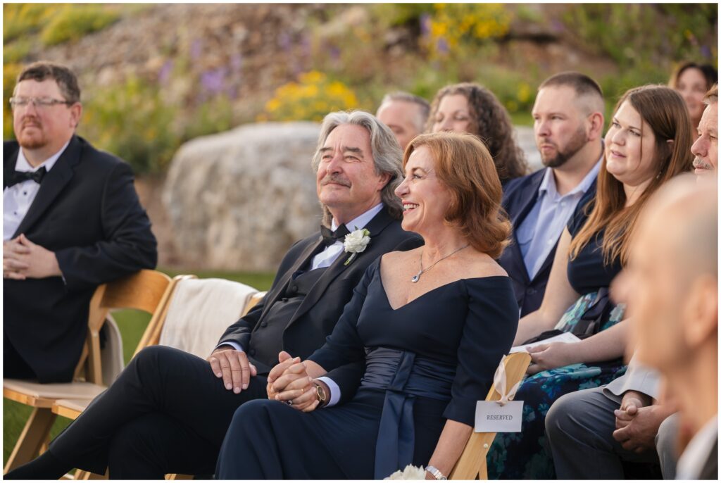 Guests smiling during wedding ceremony