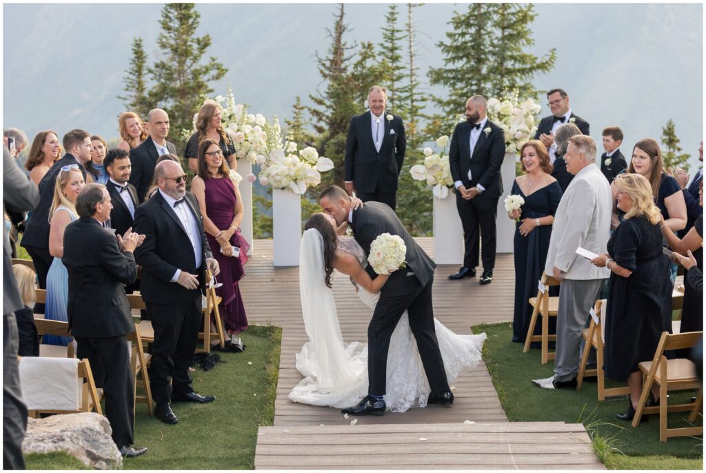 groom dips bride with kiss