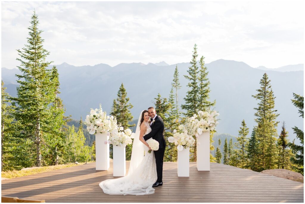 bride and groom on ceremony spot next to arrainged flowers