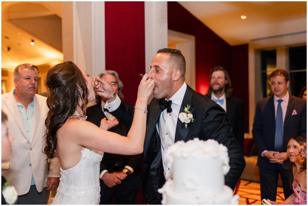 Bride feeding groom cake 