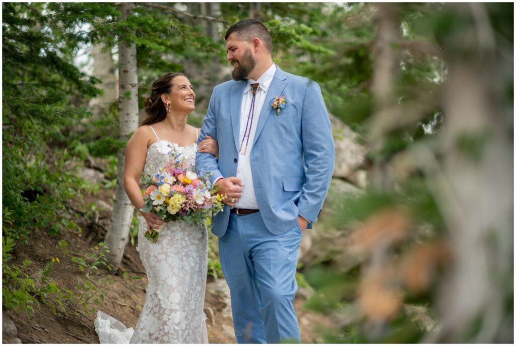 Bride and groom walking on trail in Steamboat