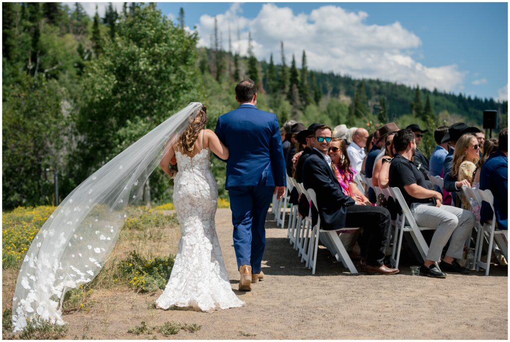 Bride being walked down isle for ceremony at Steamboat mountain