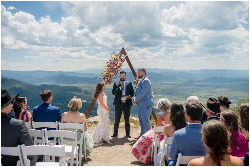 Bride and groom with officiant at the beginning of wedding ceremony at Steamboat mountain