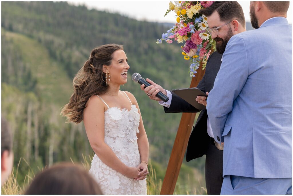 Bride speaking on microphone during ceremony at Steamboat mountain