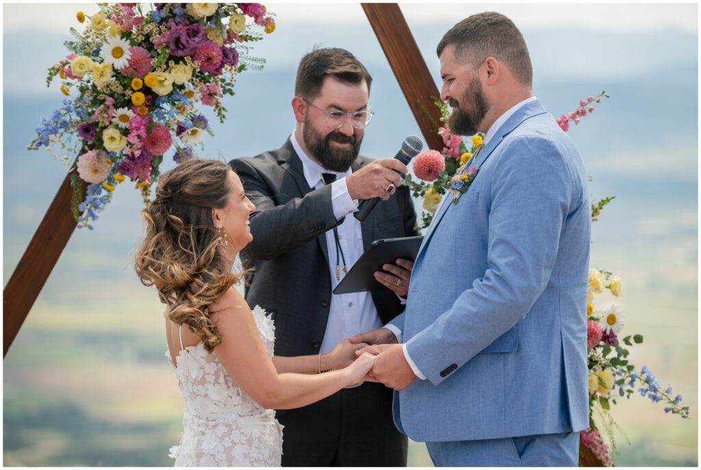 Groom speaking on mic during ceremony at Steamboat mountain