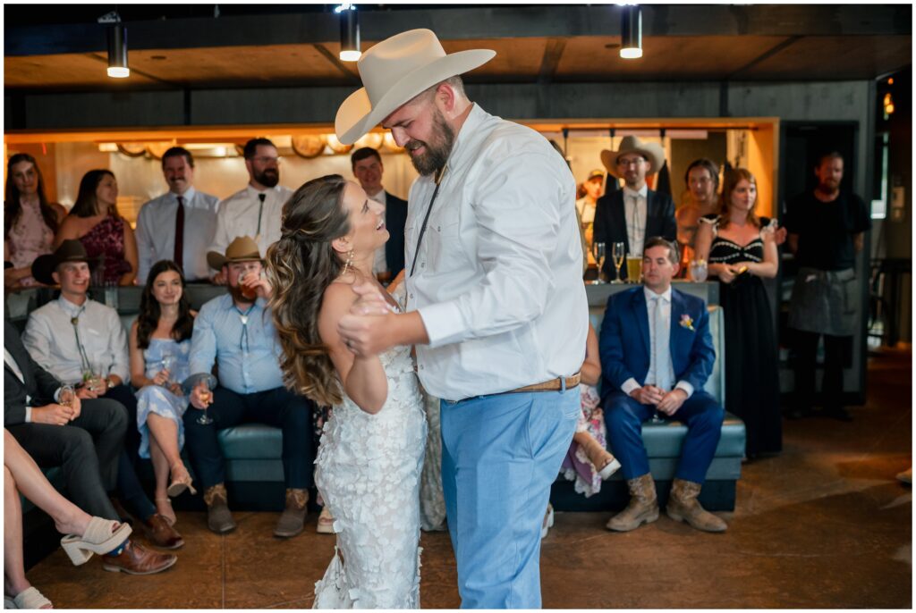 Bride and groom holding hands dancing at Table 79 in Steamboat Springs