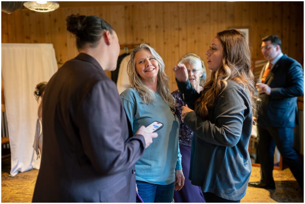 bride with friends while getting ready