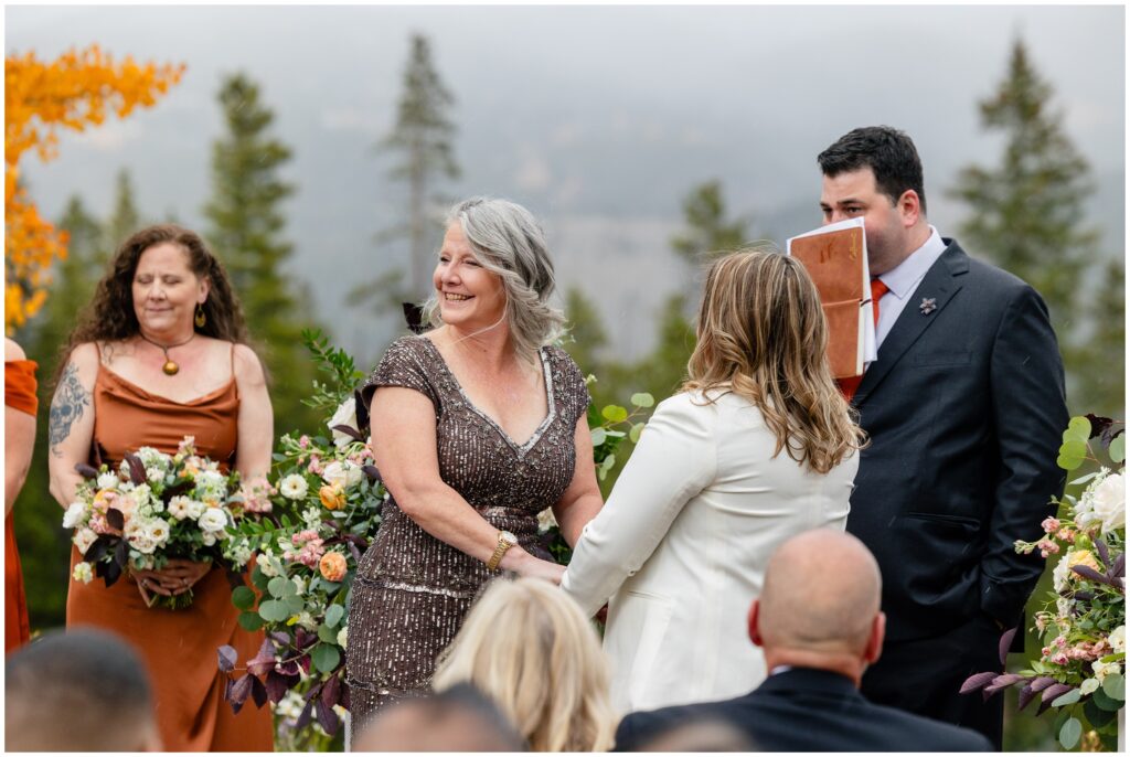 Bride looking back at guests during wedding ceremony 