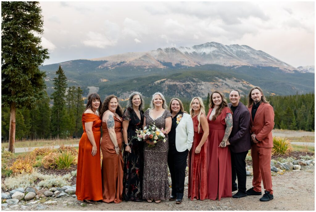 Breckenridge mountains in background at ten mile station with wedding party standing on trail