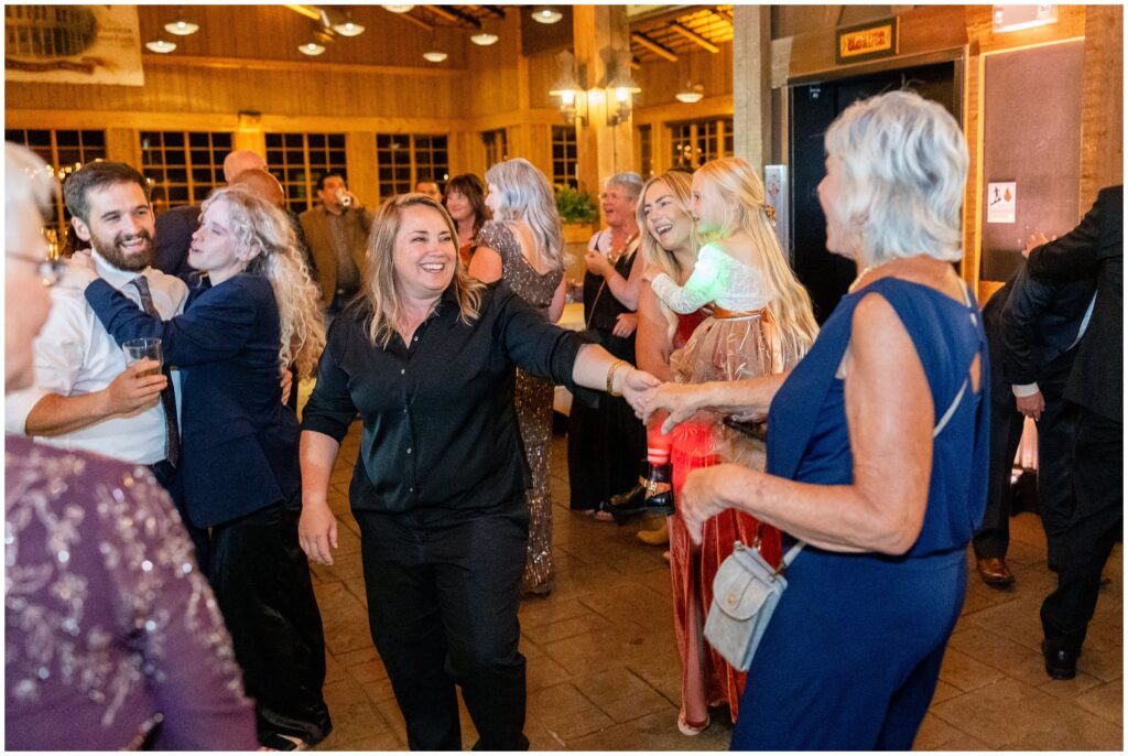 bride dancing with guests during open dancing at ten mile station